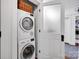 Functional laundry area with stacked washer and dryer, next to a closet at 411 Walnut St, Davidson, NC 28036