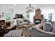 Bright living room features a brick fireplace, stylish chandelier, and comfortable seating at 411 Walnut St, Davidson, NC 28036