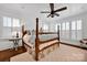 Inviting main bedroom with a four-poster bed, ceiling fan, and bright natural light at 411 Walnut St, Davidson, NC 28036