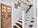 Elegant staircase with wood treads, white risers and wood-trimmed railing, featuring pantry at 411 Walnut St, Davidson, NC 28036
