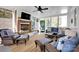 Inviting sunroom featuring wicker furniture, a brick fireplace, and abundant natural light at 411 Walnut St, Davidson, NC 28036