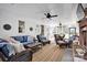 Bright sunroom boasts a striped rug, wicker furniture, and views of the outdoor greenery at 411 Walnut St, Davidson, NC 28036