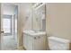 This bathroom features a vanity with white cabinetry and sink, mirror, and toilet at 4340 N Center Ne St # 508, Hickory, NC 28601