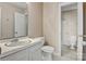 This bathroom features a vanity with white cabinetry and sink, mirror, and toilet at 4340 N Center Ne St # 508, Hickory, NC 28601