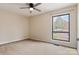 This bedroom features neutral walls and carpet, ceiling fan, and large window at 4340 N Center Ne St # 508, Hickory, NC 28601