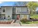 Charming gray two-story townhouse featuring a small garden, wood stairs, and a red front door at 4340 N Center Ne St # 508, Hickory, NC 28601
