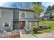 Charming gray two-story townhouse featuring a small garden, wood stairs, and a red front door at 4340 N Center Ne St # 508, Hickory, NC 28601