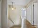 This hallway features neutral walls and carpet, a ceiling fan, and a stairway at 4340 N Center Ne St # 508, Hickory, NC 28601
