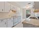 Bright kitchen showcases white cabinetry, tiled countertops, and a window with a neighborhood view at 4340 N Center Ne St # 508, Hickory, NC 28601