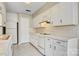 Functional kitchen with white cabinetry, tile counters, and efficient appliance layout at 4340 N Center Ne St # 508, Hickory, NC 28601