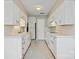 Galley kitchen featuring white cabinets, tiled countertops, and ample storage throughout at 4340 N Center Ne St # 508, Hickory, NC 28601