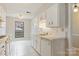 Charming kitchen with white cabinets, tiled countertops, and a window offering natural light at 4340 N Center Ne St # 508, Hickory, NC 28601