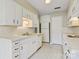 Well-maintained kitchen with white cabinets, tiled countertops, and essential appliances at 4340 N Center Ne St # 508, Hickory, NC 28601
