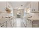 Well-lit kitchen features classic white cabinets, tiled countertops, and a bright window at 4340 N Center Ne St # 508, Hickory, NC 28601