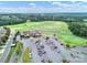 Aerial view of the lush golf course, golf cart parking, and clubhouse at 45008 Wigeon Ln # 101, Indian Land, SC 29707