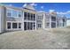 Rear view of townhomes with screened porches overlooking the expansive backyard at 45008 Wigeon Ln # 101, Indian Land, SC 29707