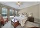 Comfortable bedroom featuring a ceiling fan, neutral walls, and large windows with drapery at 45008 Wigeon Ln # 101, Indian Land, SC 29707