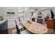 Open-concept dining area adjacent to the living room and kitchen with rich hardwood flooring and wainscoting at 45008 Wigeon Ln # 101, Indian Land, SC 29707