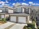 Charming brick-accented townhome featuring a two-car garage and well-maintained landscaping under a bright, partly cloudy sky at 45008 Wigeon Ln # 101, Indian Land, SC 29707