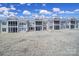 View of modern condo buildings boasting screened-in back porches on a sunny day at 45008 Wigeon Ln # 101, Indian Land, SC 29707