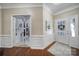 Elegant foyer featuring hardwood floors, detailed moldings, and a view through glass doors into an office at 45008 Wigeon Ln # 101, Indian Land, SC 29707