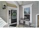 Welcoming front porch with neutral decor, features a stylish black door with wreath and comfortable seating area at 45008 Wigeon Ln # 101, Indian Land, SC 29707