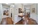 Inviting hallway featuring hardwood floors, elegant wainscoting, and an open view into the adjacent living spaces at 45008 Wigeon Ln # 101, Indian Land, SC 29707