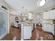 Open floorplan with view from kitchen to living room with granite countertops and breakfast bar at 45008 Wigeon Ln # 101, Indian Land, SC 29707
