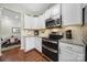 Modern kitchen with stainless steel appliances, granite countertops, and white cabinets at 45008 Wigeon Ln # 101, Indian Land, SC 29707