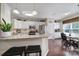 Open kitchen boasts granite countertops, stainless appliances, white cabinetry, and eat-in breakfast nook at 45008 Wigeon Ln # 101, Indian Land, SC 29707