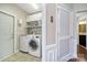 Well-lit laundry room with modern appliances and ample storage space on shelves and cabinets at 45008 Wigeon Ln # 101, Indian Land, SC 29707