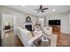Comfortable living room with hardwood floors, a fireplace, neutral decor, and an open layout to the rest of the home at 45008 Wigeon Ln # 101, Indian Land, SC 29707