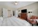 Bright bedroom with large TV, ceiling fan, neutral paint and connecting doorways at 45008 Wigeon Ln # 101, Indian Land, SC 29707