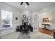 Bright home office featuring a ceiling fan, a well-equipped desk area, and an open doorway at 45008 Wigeon Ln # 101, Indian Land, SC 29707