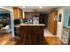 Functional kitchen with wooden cabinets, breakfast bar, and white appliances at 4807 Lon Parker Rd # 1, Waxhaw, NC 28173