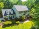 Picturesque aerial view of a traditional home with a lush green lawn and mature trees at 5232 Silchester Ln, Charlotte, NC 28215