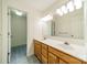 Bathroom featuring double sinks, large mirror, lighting, and a view to the shower at 5232 Silchester Ln, Charlotte, NC 28215