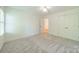 Bright bedroom featuring neutral carpet, fresh paint, ceiling fan and closet space at 5232 Silchester Ln, Charlotte, NC 28215