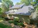 Two-story home with a neutral color scheme, mature landscaping, and brick chimney at 5232 Silchester Ln, Charlotte, NC 28215