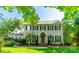 Charming two-story home with a manicured lawn, mature trees, and classic architectural details at 5232 Silchester Ln, Charlotte, NC 28215