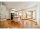 Open-concept kitchen with white cabinetry, granite countertops, and wood floors throughout at 5232 Silchester Ln, Charlotte, NC 28215