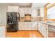 Well-lit kitchen with granite countertops, a modern refrigerator, and white cabinets at 5232 Silchester Ln, Charlotte, NC 28215