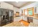 Bright kitchen featuring stainless steel appliances, a modern refrigerator, and a window over the sink at 5232 Silchester Ln, Charlotte, NC 28215