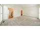 Spacious living room with plush carpet and open doorways at 5232 Silchester Ln, Charlotte, NC 28215