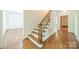 Elegant staircase with wooden banister and treads, leading to the upper level of the home at 5232 Silchester Ln, Charlotte, NC 28215