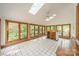 Bright sunroom with tiled floors, multiple windows, skylights, and a unique bar area at 5232 Silchester Ln, Charlotte, NC 28215