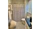 Bathroom featuring a shower-tub combo with blue and white striped curtain and a stack of fresh towels at 7412 Broken Oak Ln, Charlotte, NC 28226