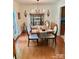 Dining room with wood floors, chandelier, and built-in cabinet, perfect for Gathering meals at 7412 Broken Oak Ln, Charlotte, NC 28226