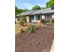 Charming ranch-style home with well-manicured landscaping and a light blue front door at 7412 Broken Oak Ln, Charlotte, NC 28226