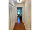 Hallway with hardwood floors, closet space, and a view into another room at 7412 Broken Oak Ln, Charlotte, NC 28226